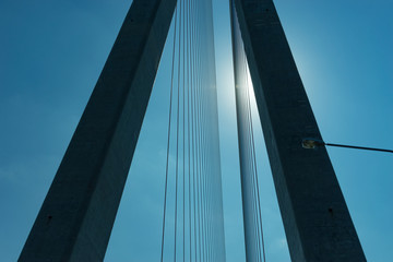 Details of the Russian bridge on the background of the blue sky in the backlight.