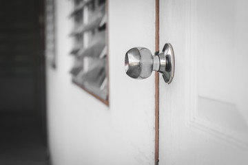 knob on white door with mysterious background