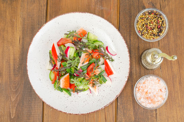 Fresh vegetable salad with crab sticks. 
