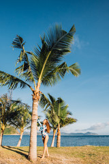 beautiful girl near palm trees in front of the sea in Sanya