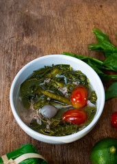 Hot, sour and spicy Basella alba or Ceylon Spinach leaf with fermented sausage soup. Northern Thai food with high vitamin vegetable.