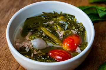 Hot, sour and spicy Basella alba or Ceylon Spinach leaf with fermented sausage soup. Northern Thai food with high vitamin vegetable.