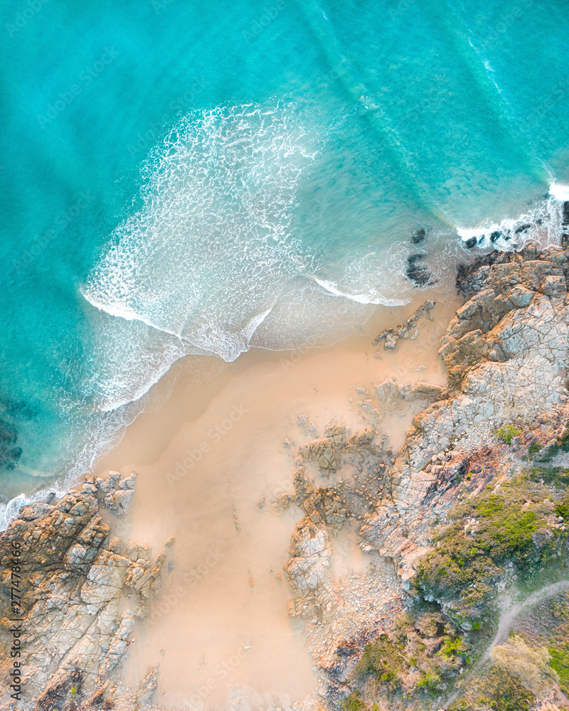 Wall mural Beautiful beach and water at sunrise with people standing in front of wave and on white sand on the Gold Coast. Queensland New South Wales Brisbane Byron Bay Sunshine Coast Noosa Bondi Manly