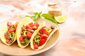 Plate with tasty fresh tacos on marble background