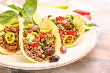 Plate with tasty fresh tacos on marble background, closeup