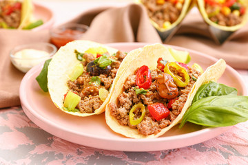 Plate with tasty fresh tacos on table