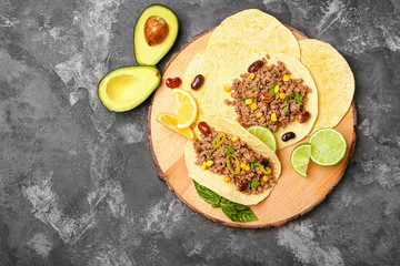 Tasty fresh tacos on grunge background