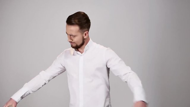 Young man reading document contract and angry tearing paper