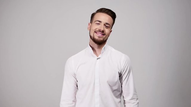 Young beard man showing heart sign. I love you. Valentine love gesture