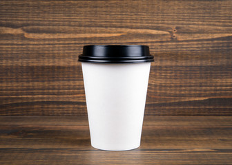 Coffee cup with copy space on a wooden background