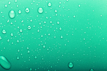 Drops of water on a color background. Selective focus. Green. Toned