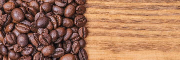 Coffee bean. The background of roasted coffee beans is brown on wooden boards. layout. Flat lay.