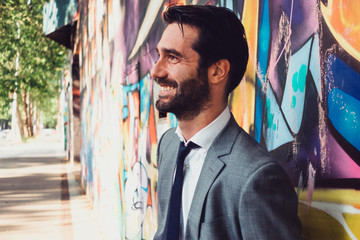 urban portrait of a smiling and elegant confident man. business, fashion and street lifestyles...