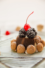 Christmas Tiramisu with biscuits, blackberries and cherry on top