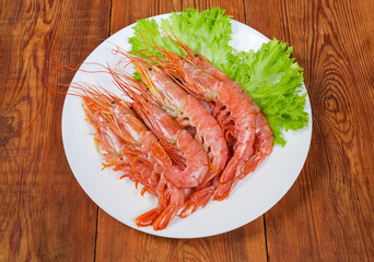 Argentinian red shrimps with lettuce leaves on dish