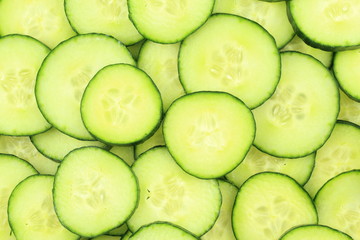 slices of fresh green cucumbers food background texture