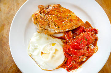 Close up of Fried chicken fillet with garnish of tomato