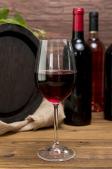 Wooden barrel with bottle and glass of wine