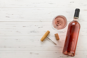 Top view wine bottle with glass on wooden background