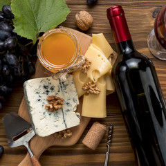 Wine with food on wooden background