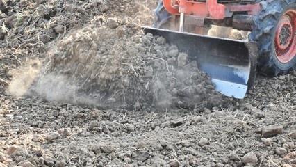 tractor push clot soil after pour from truck