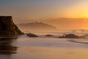 Fototapeta premium Hazy morning lighthouse beach