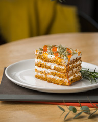 Honey carrot cake with pumpkin seeds on a table in a cafe