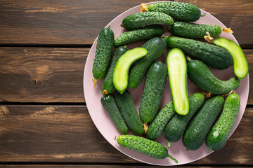cucumbers in a bowl on wooden surface