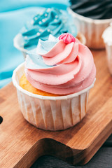 Close up of some decadent gourmet cupcakes frosted with a variety of frosting flavors