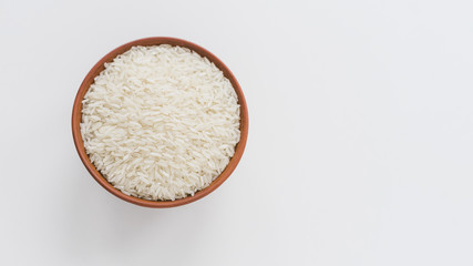 High angle view of white rice in bowl isolated on white backdrop