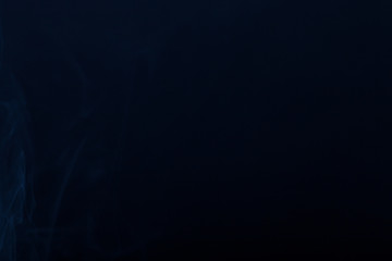 Cloud of smoke on black background. Selective focus. Toned