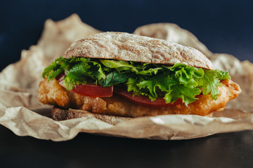 fried fish Sandwich with lettuce, tomato with tartar sauce. author's recipe street food
