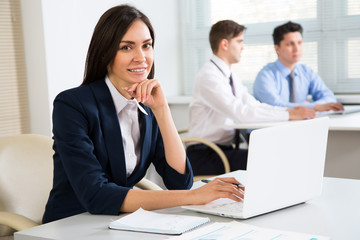 Fototapeta premium Young business woman smiling looking at camera