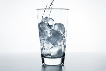 Beautiful splash of water in a glass with ice