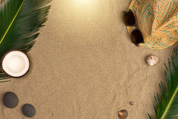 Fototapeta na wymiar Frame of straw hat, sunglasses, seashells. Traveler accessories on sand. Travel vacation concept. Summer background