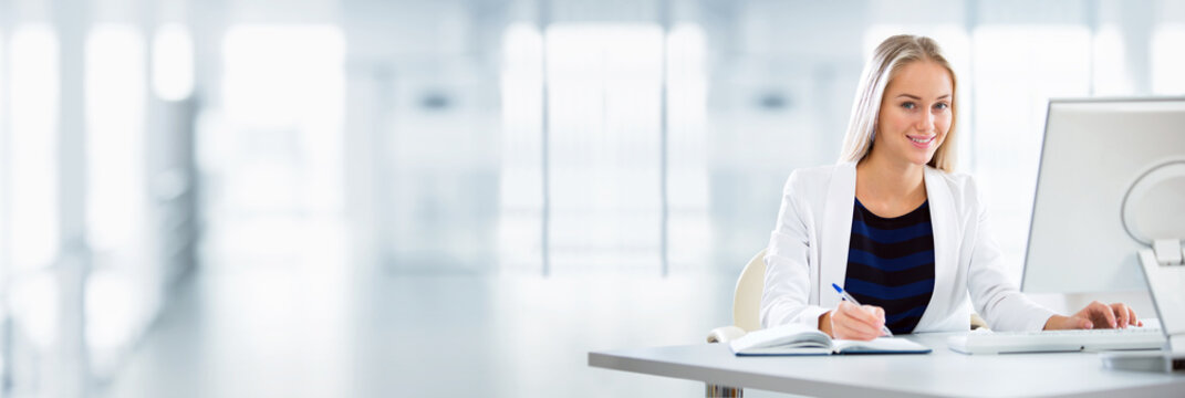 Young business woman using computer at office