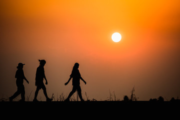 Fototapeta na wymiar woman walking on sunset background