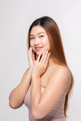 Beautiful Attractive Charming Asian young woman smile with white teeth and touching soft cheek feeling so happy and cheerful with healthy skin,isolated on white background,Beauty Cosmetology Concept