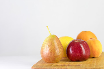 Naklejka na ściany i meble red apple, pear, lemon, orange, peach on white background, copy space