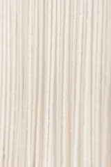 Close up of cotton macrame panel yarn in a minimalistic scandinavian wall. Texture. Background.