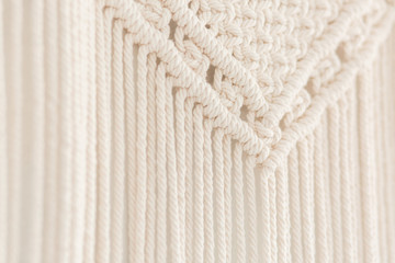 Close up of handmade cotton macrame panel. Texture. Background.