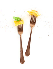 Italian pasta design. An overhead photo of two vintage forks with ravioli, basil and pepper on a...