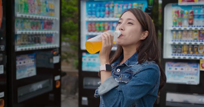 Woman bought a bottle of juice on vending machine