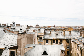 Fototapeta premium Beautiful top view of the roofs of authentic houses in St. Petersburg in Russia.
