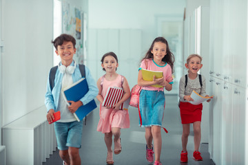 Cheerful happy children feeling happy after finishing school day