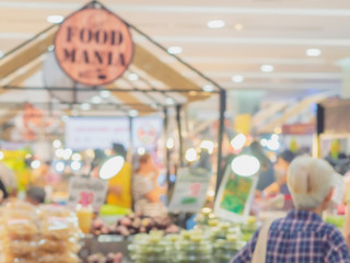 Abstract blurred old woman walking in food mania festival in department store.