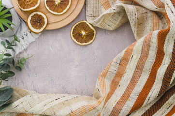 Dried lemon slices with stripes textile on concrete backdrop