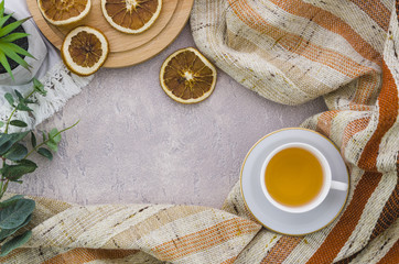 An elevated view of dried lemon slices with stripes textile on concrete backdrop