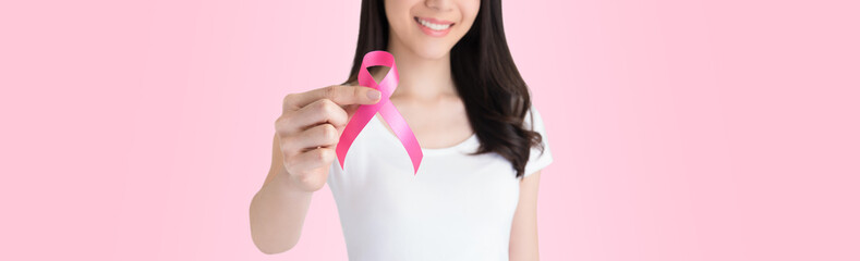 Woman giving pink ribbon supporting breast cancer awareness campaign