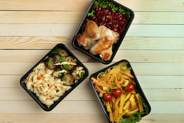 business lunch in food boxes, roast chicken wings, steamed vegetables, stewed meat, ready meal to eat